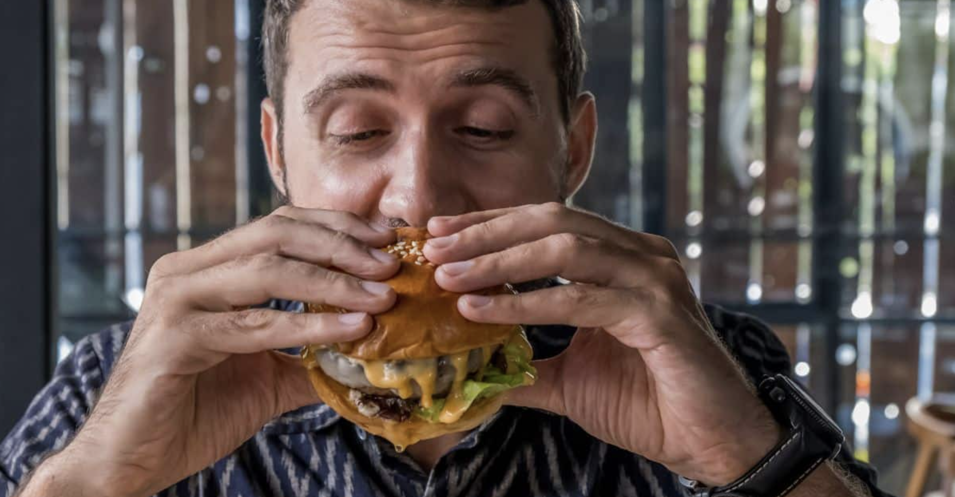 dude eating a plant-based burger